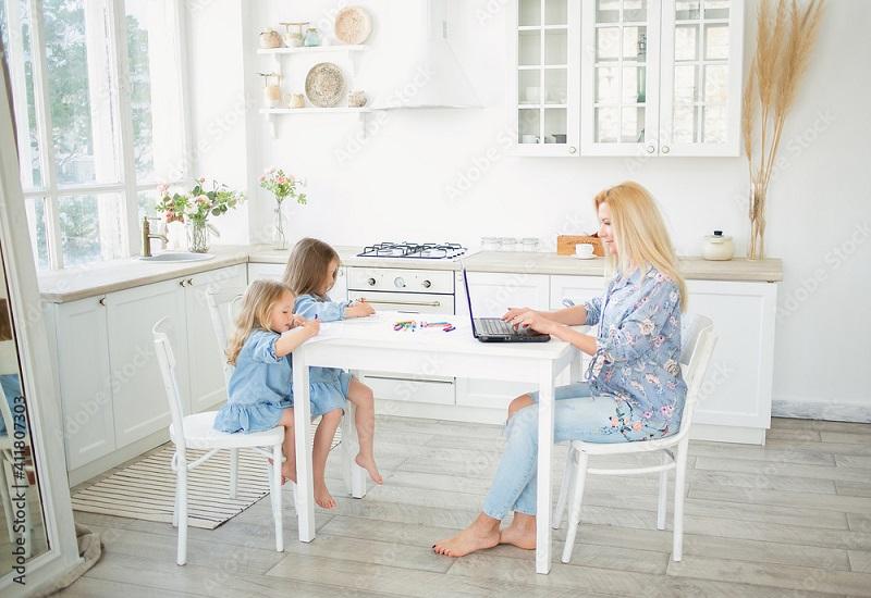 Woman working from home with children